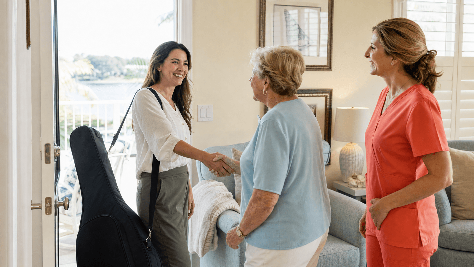 Hospice patient receiving a calming complementary therapy with a clinician in plain coral-orange scrubs nearby