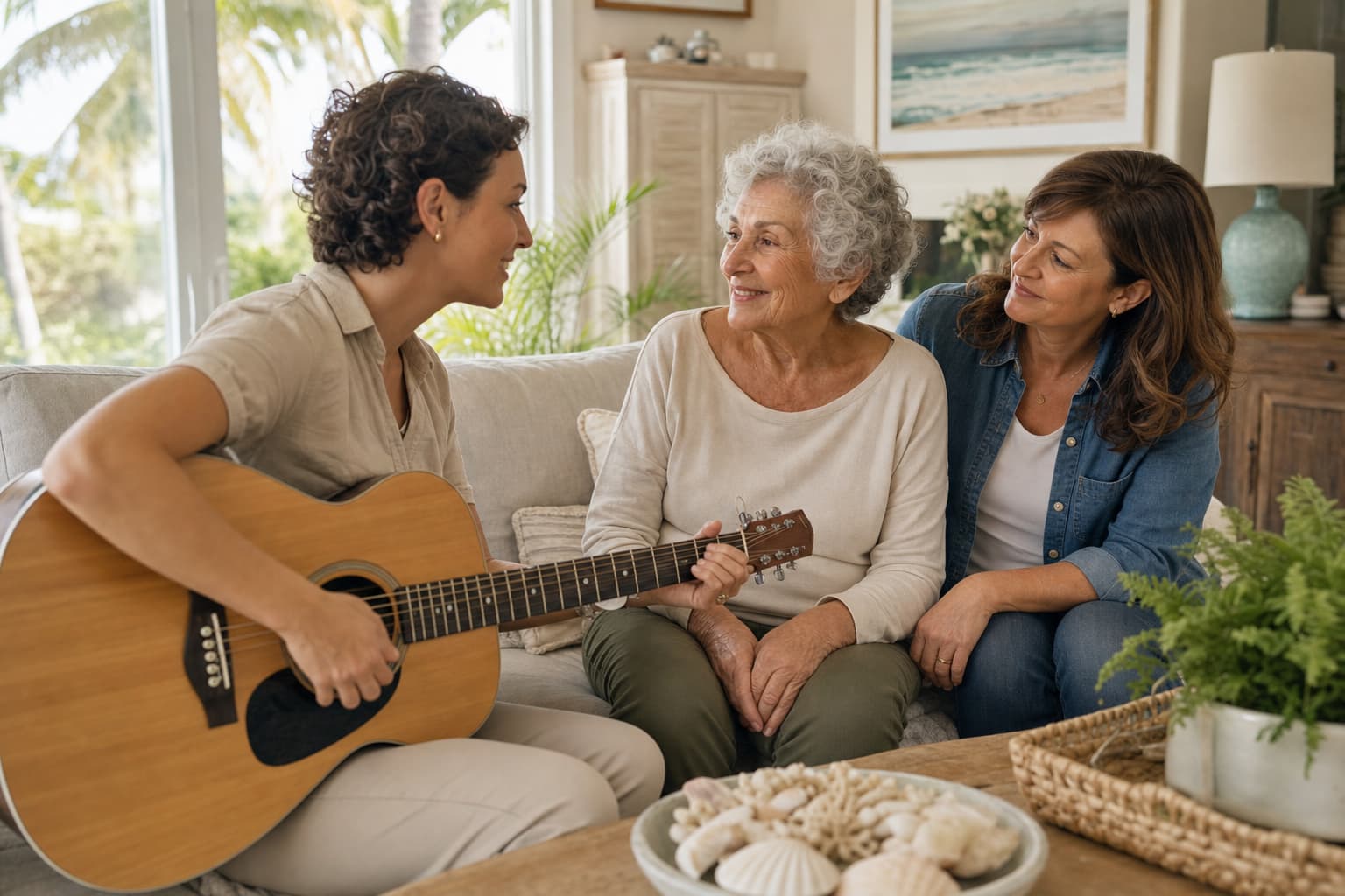 Music therapist playing guitar with a hospice patient and family member at home