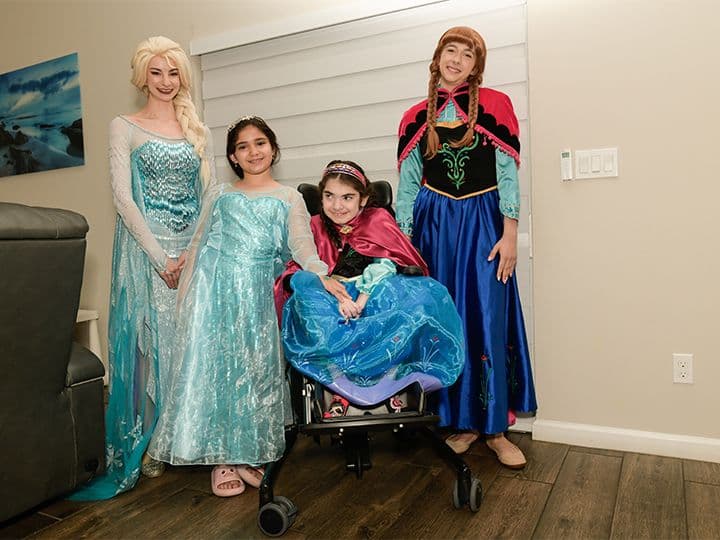 Olivia and Valerie celebrating with Princesses Elsa and Anna during a Little Treasures princess party