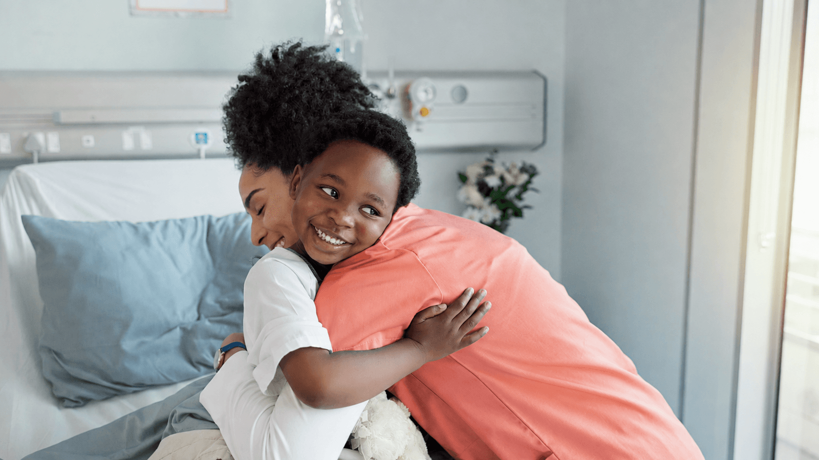 A child receiving pediatric care alongside a caregiver